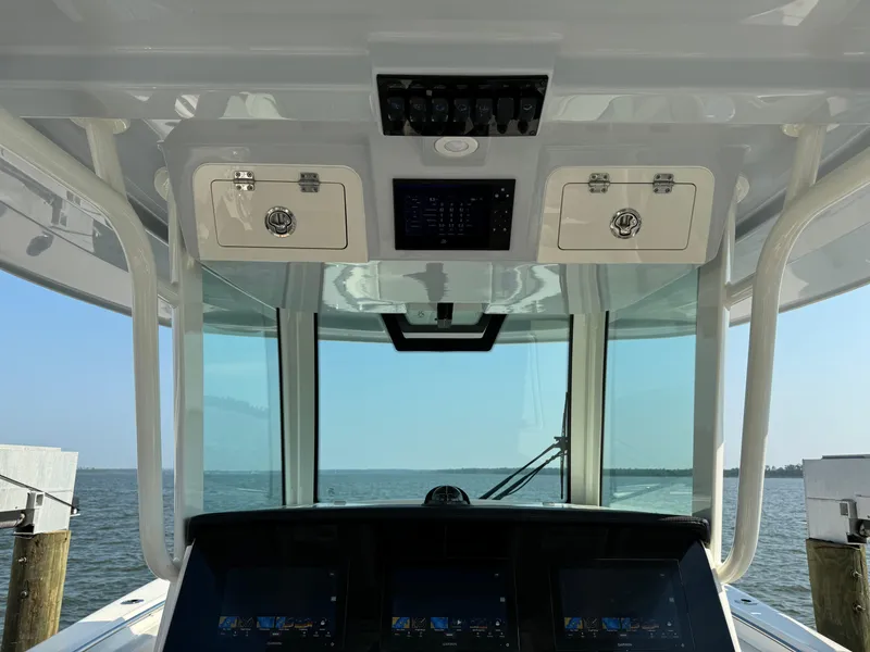 Slide: The Image of 2024 Sailfish 360 CC boat cockpit with advanced navigation system and ocean view. - 29