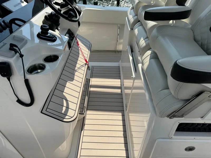 Slide: The Image of 2024 Sailfish 360 CC boat interior with helm and seating area. - 32