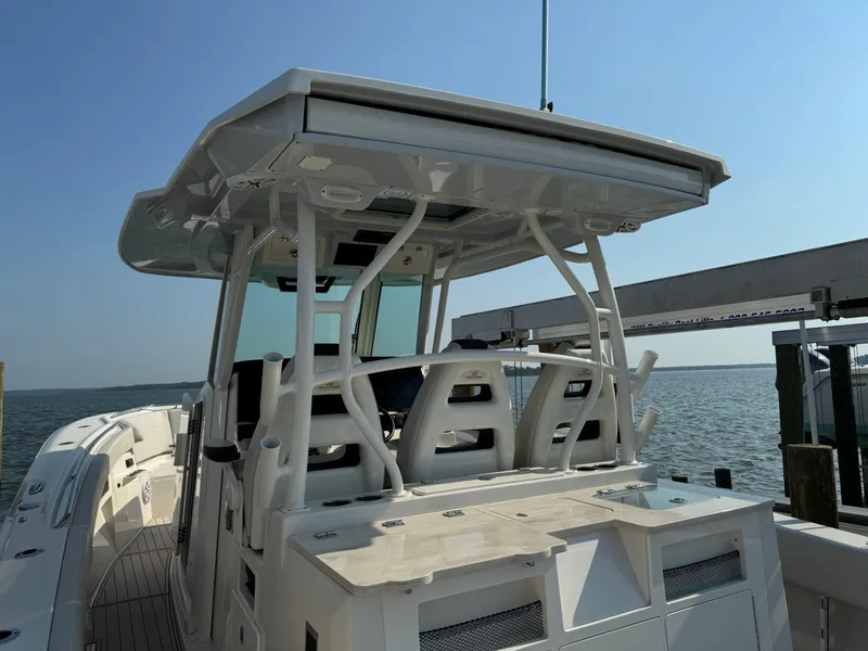 Slide: The Image of 2024 Sailfish 360 CC boat with sleek design, docked by the water. - 34