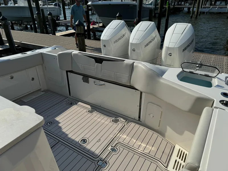 Slide: The Image of 2024 Sailfish 360 CC boat interior with triple Mercury engines at dock. - 35