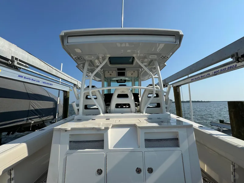 Slide: The Image of 2024 Sailfish 360 CC boat docked, showcasing sleek design and spacious deck. - 38