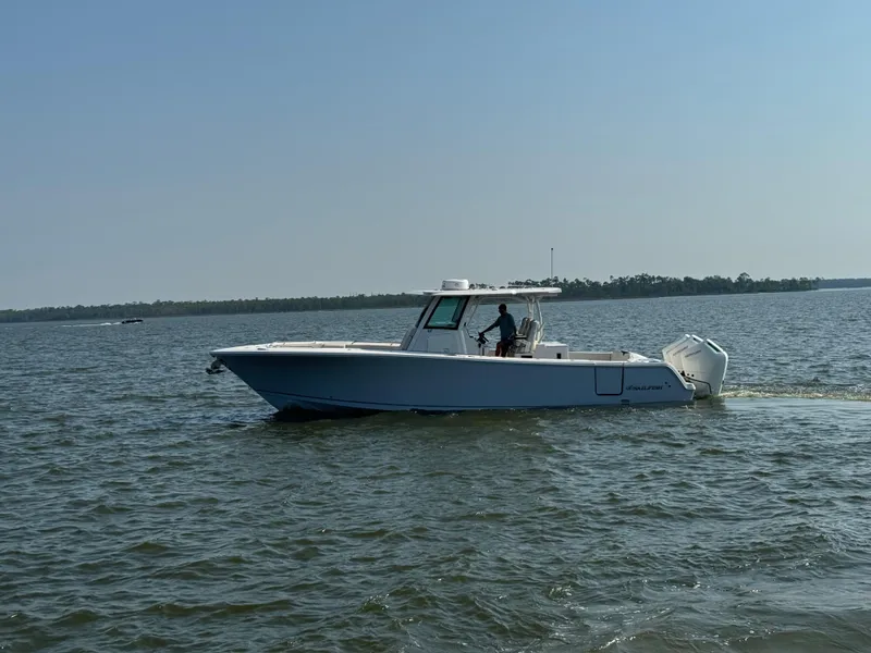 Slide: The Image of 2024 Sailfish 360 CC boat cruising on open water. - 39