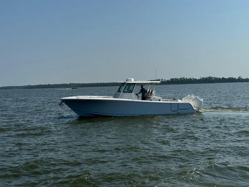 Slide: The Image of 2024 Sailfish 360 CC boat cruising on open water under clear skies. - 40