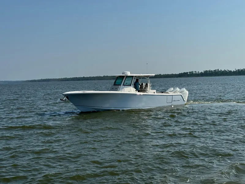 Slide: The Image of 2024 Sailfish 360 CC boat cruising on open water. - 41