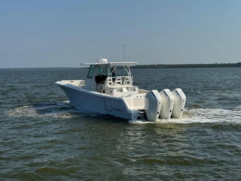 Slide: The Image of 2024 Sailfish 360 CC boat cruising on open water with triple engines. - 5