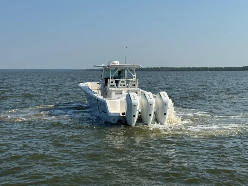 Slide: The Image of 2024 Sailfish 360 CC boat cruising on open water with triple engines. - 7