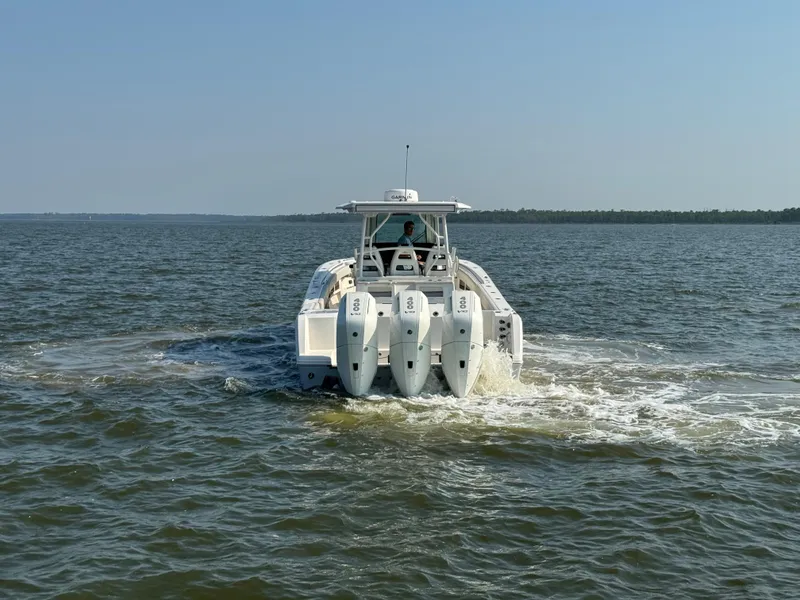 Slide: The Image of 2024 Sailfish 360 CC boat cruising on open water, rear view. - 9