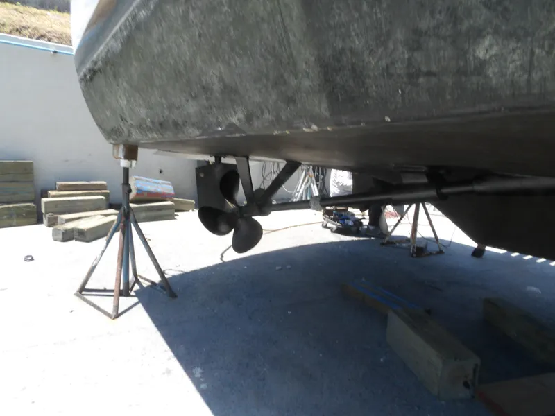 Slide: The Image of 1967 Hatteras Convertible boat under maintenance, showing propeller and hull on stands. - 15