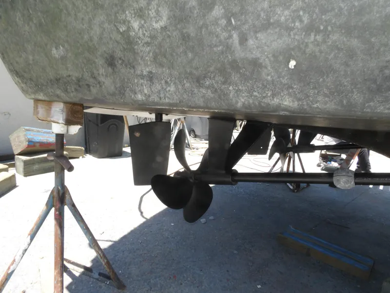 Slide: The Image of 1967 Hatteras Convertible boat propeller and hull on stands, undergoing maintenance. - 16