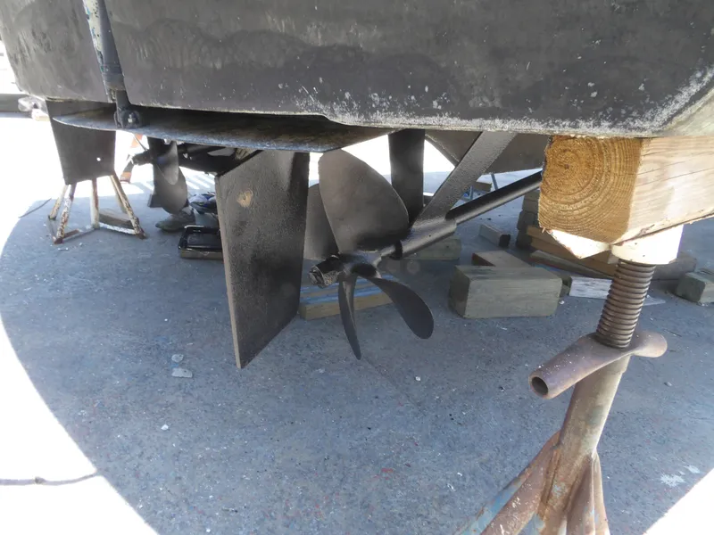 Slide: The Image of 1967 Hatteras Convertible boat propeller and rudder on dry dock. - 17