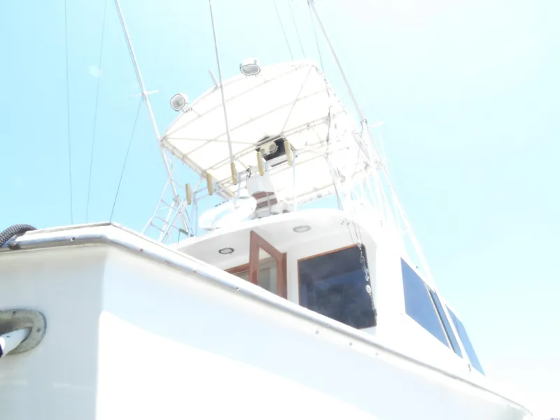 Slide: The Image of 1967 Hatteras Convertible boat with flybridge against a clear blue sky. - 19
