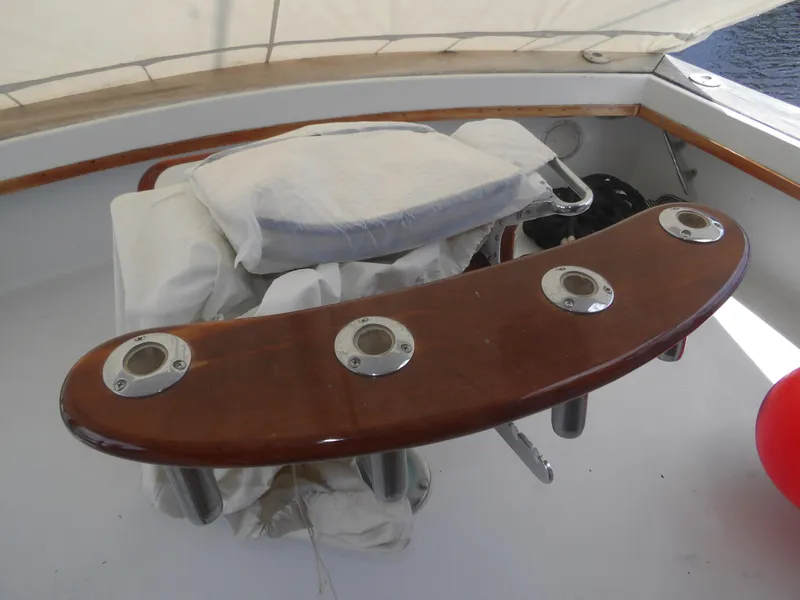 Slide: The Image of 1967 Hatteras Convertible boat interior with wooden rod holders and covered seating. - 28
