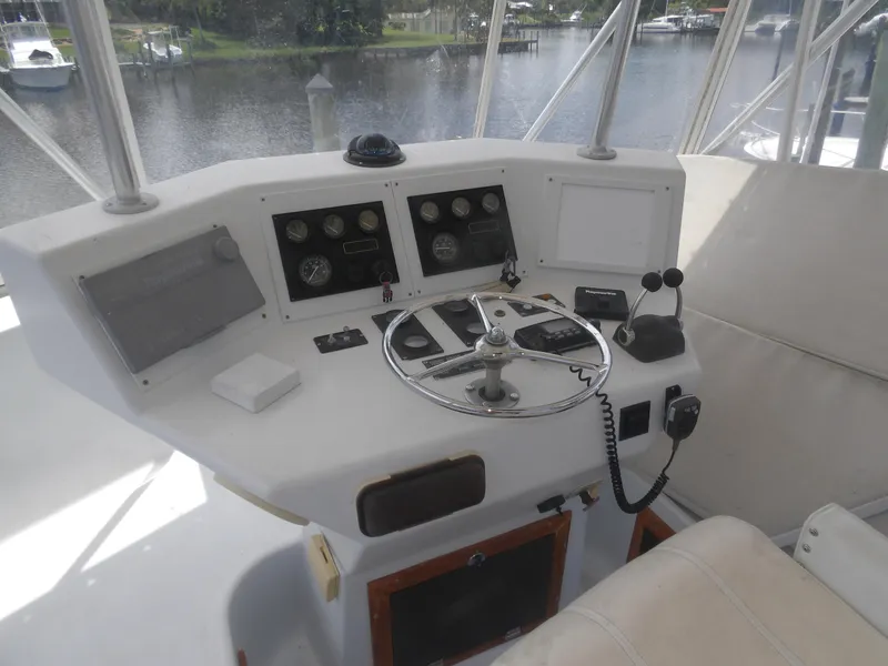 Slide: The Image of Helm of a 1967 Hatteras Convertible boat with steering wheel and controls. - 34