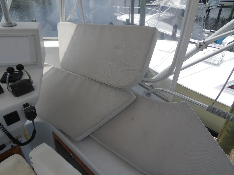 Slide: The Image of 1967 Hatteras Convertible boat interior with white cushions and control panel. - 37