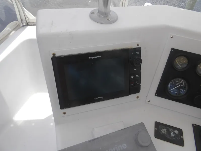 Slide: The Image of Control panel of a 1967 Hatteras Convertible boat with Raymarine navigation system. - 38