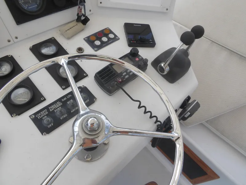Slide: The Image of 1967 Hatteras Convertible boat helm with steering wheel and control panel. - 41