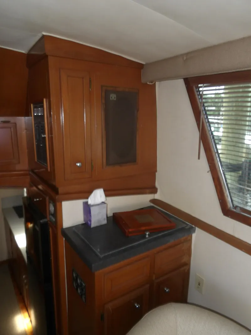 Slide: The Image of Interior of a 1967 Hatteras Convertible yacht with wooden cabinets and countertop. - 49