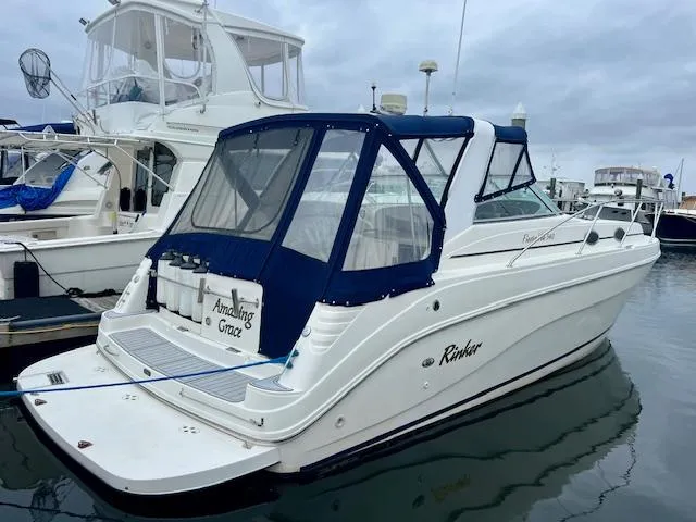 The Image of 2000 Rinker Fiesta Vee 342 boat docked at marina with blue canopy. - 0