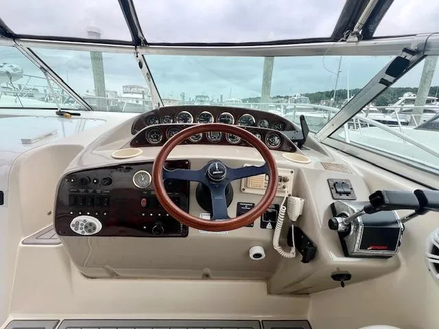 Slide: The Image of Cockpit of 2000 Rinker Fiesta Vee 342 with steering wheel and control panel. - 10