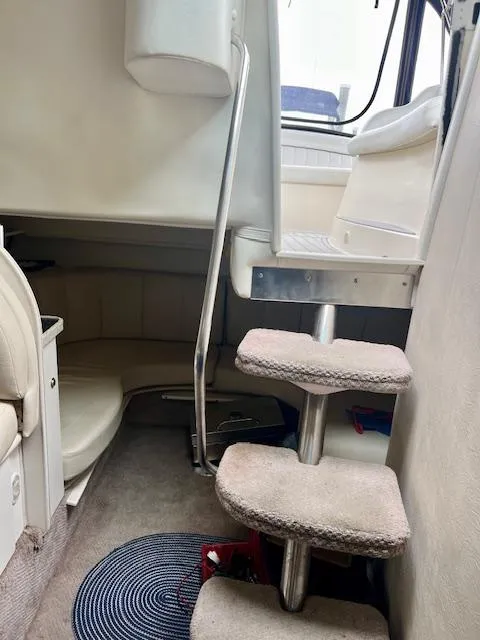 Slide: The Image of Interior of 2000 Rinker Fiesta Vee 342 boat with carpeted stairs and seating area. - 13