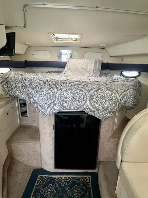 Slide: The Image of Interior of 2000 Rinker Fiesta Vee 342 boat with bed and compact fridge. - 14