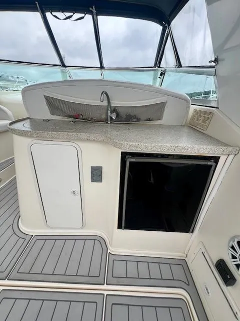 Slide: The Image of 2000 Rinker Fiesta Vee 342 boat interior with kitchenette and sink. - 4