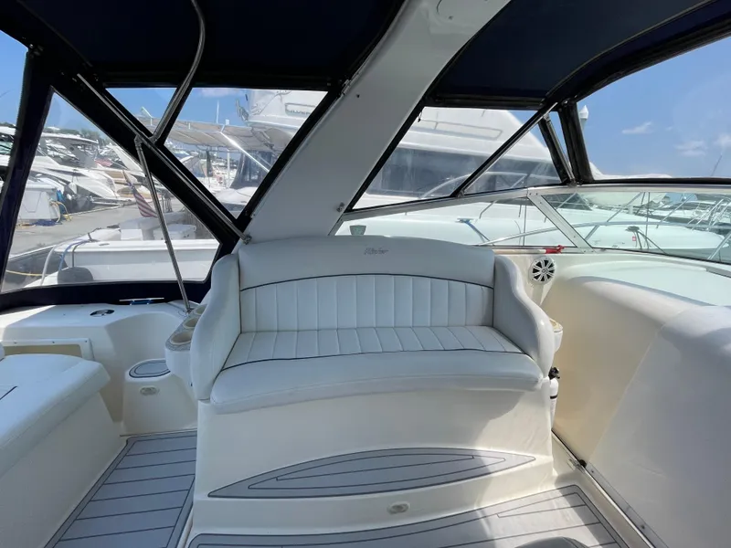 Slide: The Image of Interior of a 2000 Rinker Fiesta Vee 342 boat with white seating and windows. - 8