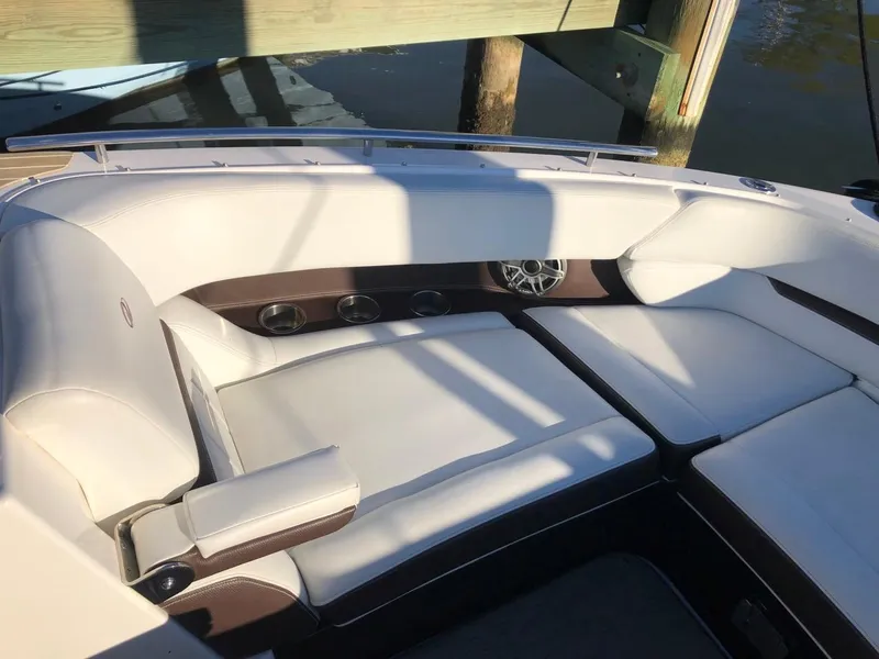 Slide: The Image of 2017 Regal 2800 boat interior with white cushioned seating and speaker system. - 12