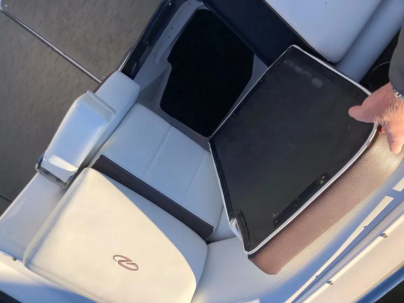 Slide: The Image of 2017 Regal 2800 boat interior with white seating and storage compartment. - 16