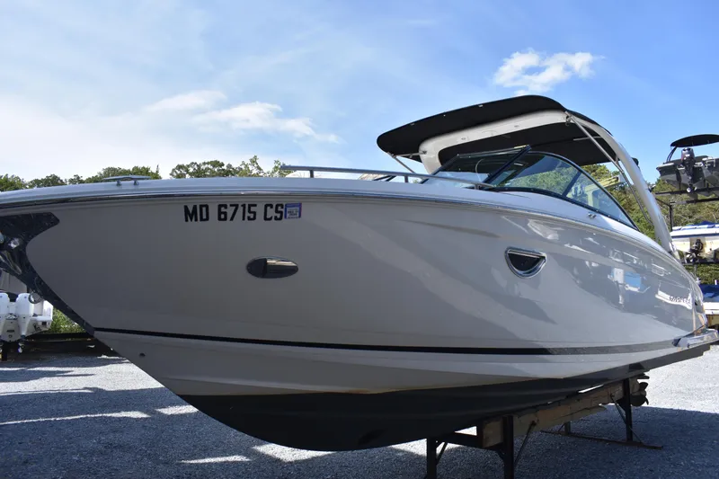 Slide: The Image of 2017 Regal 2800 boat on trailer under clear sky. - 2