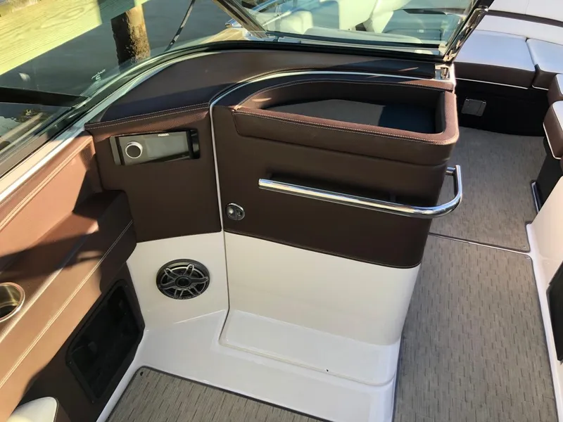Slide: The Image of Interior of 2017 Regal 2800 boat with brown and white seating and speaker. - 21