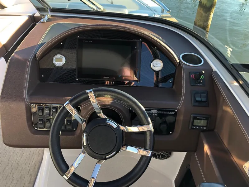 Slide: The Image of 2017 Regal 2800 boat dashboard with steering wheel and control panel. - 22