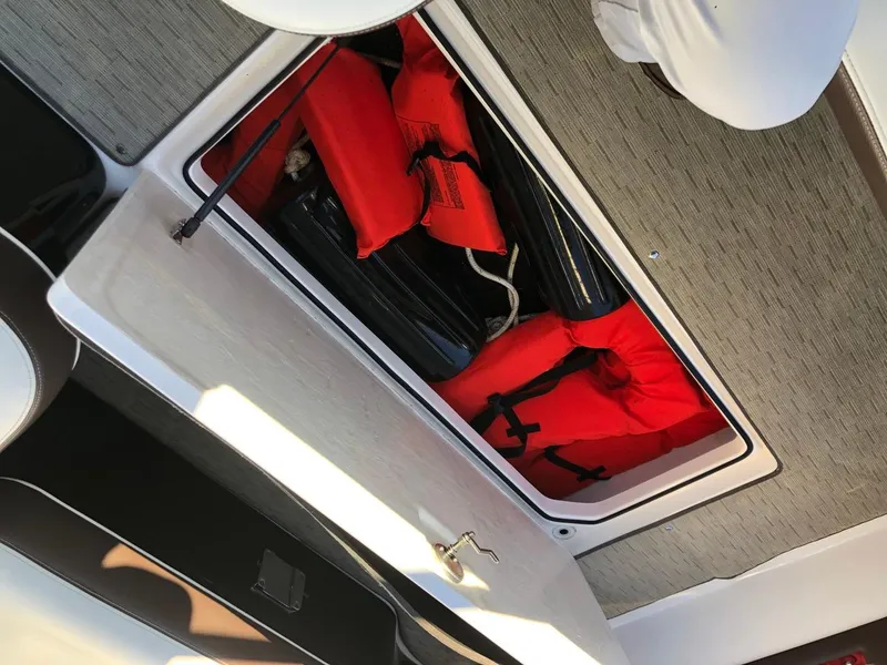 Slide: The Image of Regal 2800 boat storage compartment with life jackets, 2017 model. - 34