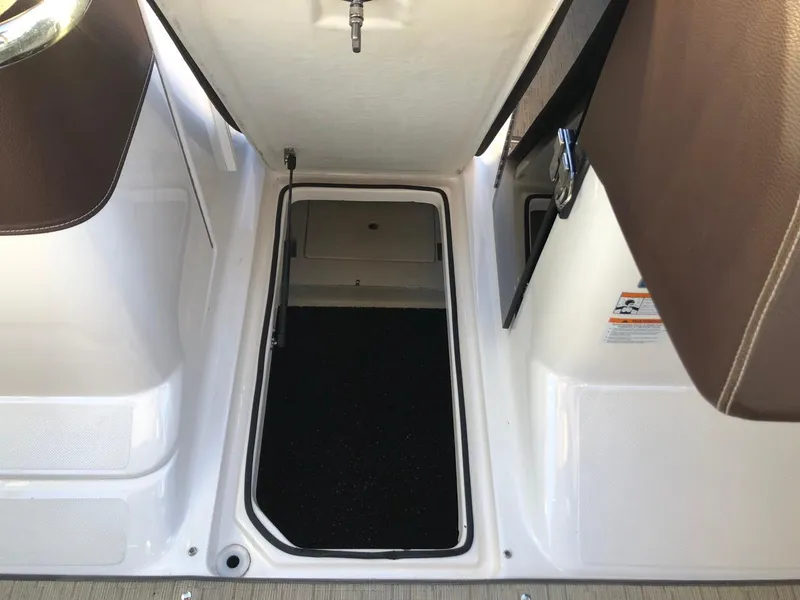 Slide: The Image of Open storage compartment on a 2017 Regal 2800 boat interior. - 35