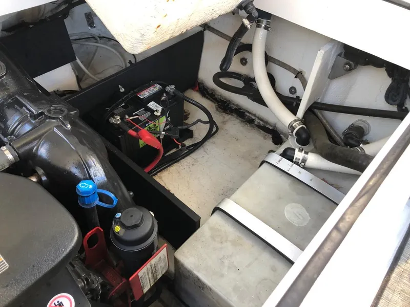 Slide: The Image of Engine compartment of 2017 Regal 2800 boat, showing battery and hoses. - 40