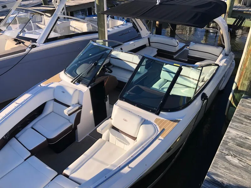 Slide: The Image of 2017 Regal 2800 boat side view with logo, clear sky background. - 45