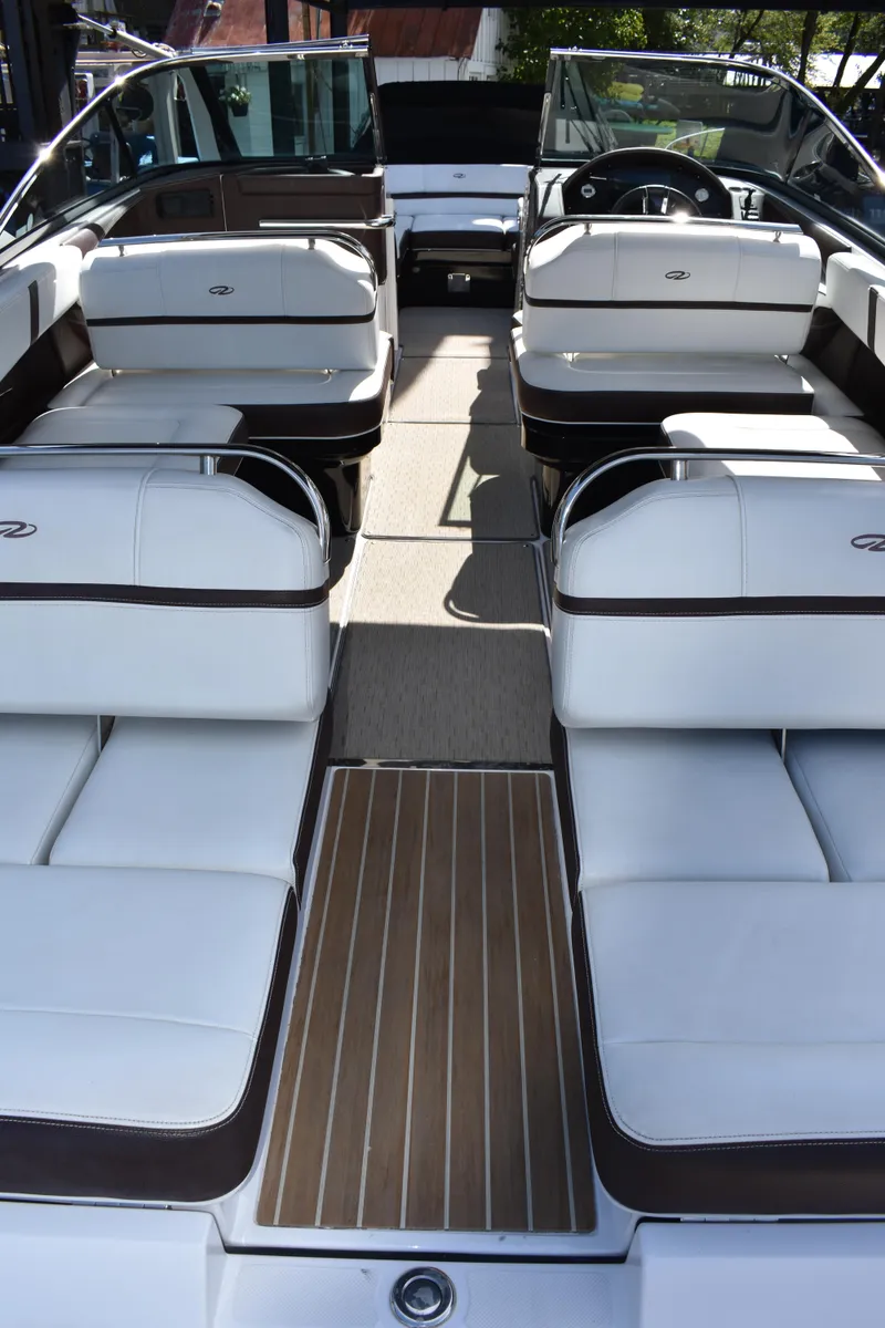 Slide: The Image of 2017 Regal 2800 boat interior with white seating and wood accents. - 49