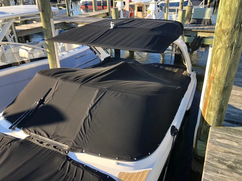 Slide: The Image of 2017 Regal 2800 boat with black cover docked at marina. - 8