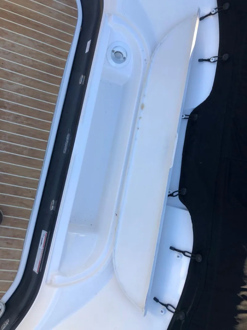 Slide: The Image of 2017 Regal 2800 boat interior with white and wood accents. - 9