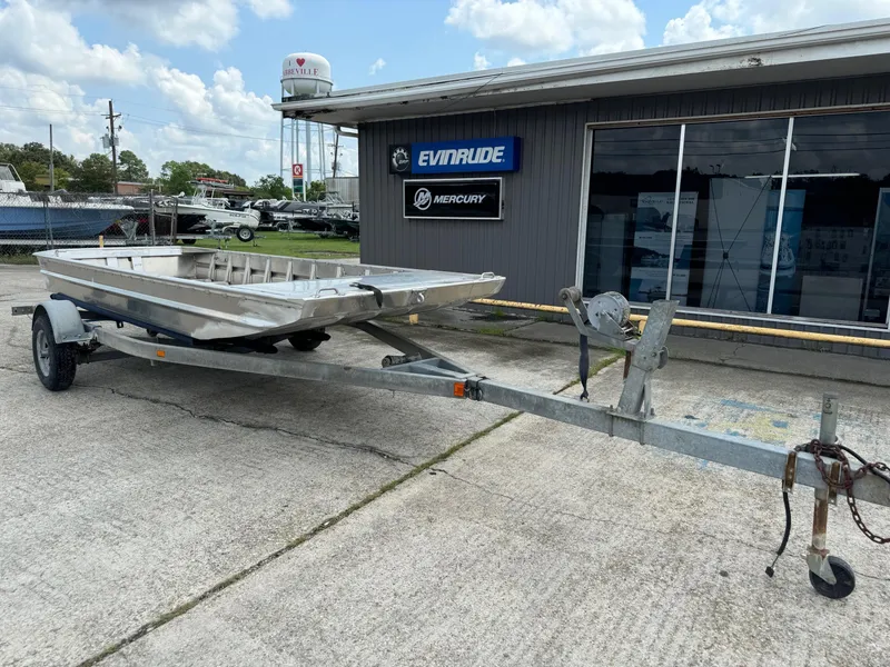 The Image of 2024 Go-Devil 16 x 60 Crawfish boat on trailer outside dealership. - 1