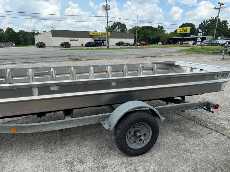 Slide: The Image of 2024 Go-Devil 16 x 60 Crawfish boat on trailer in parking lot. - 6
