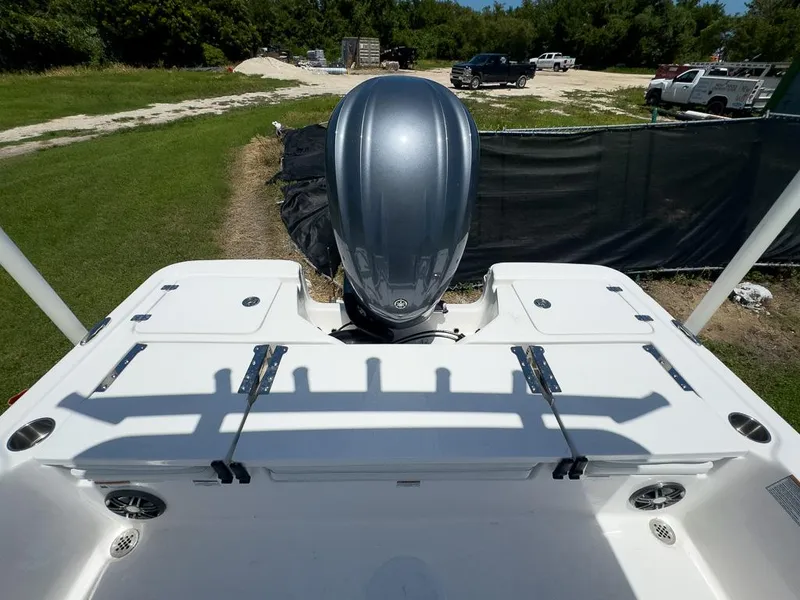 Slide: The Image of 2025 Sea Fox 231 Bay Fox boat with outboard motor, parked on grass. - 16