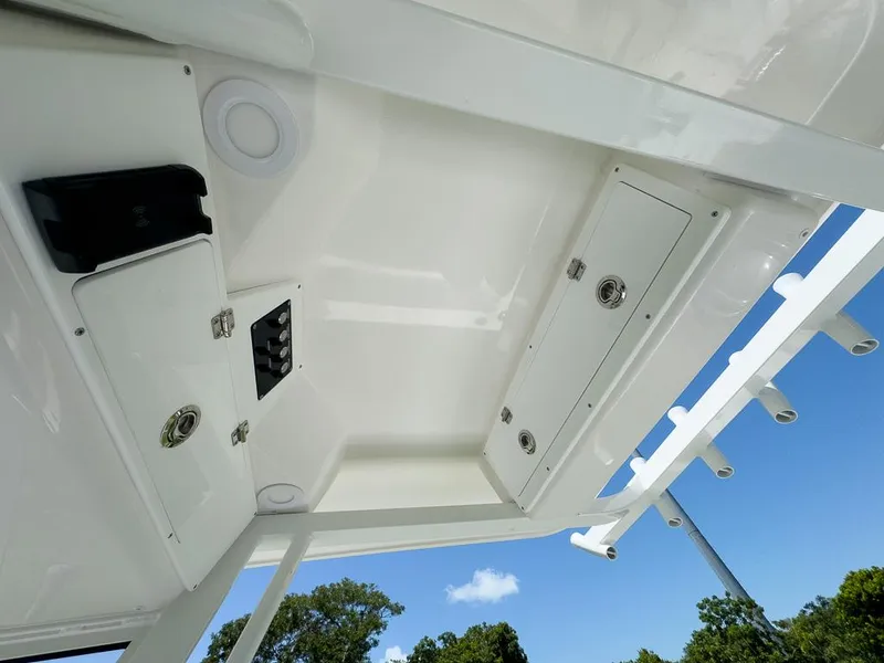 Slide: The Image of 2025 Sea Fox 231 Bay Fox boat interior with storage compartments and rod holders. - 20