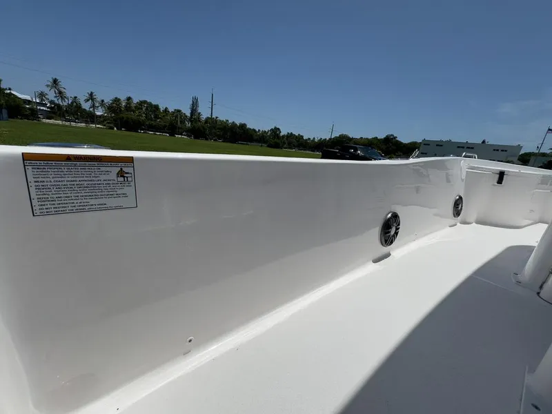 Slide: The Image of 2025 Sea Fox 231 Bay Fox boat interior with sleek white design and speaker details. - 23