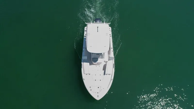 Slide: The Image of Aerial view of 2025 Sea Fox 231 Bay Fox boat cruising on green water. - 8