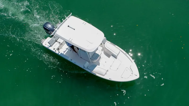Slide: The Image of Aerial view of 2025 Sea Fox 231 Bay Fox boat cruising on green water. - 9