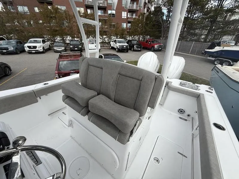 Slide: The Image of 2025 Sea Hunt Gamefish 28 Coffin Box boat with gray seating in a parking lot. - 11