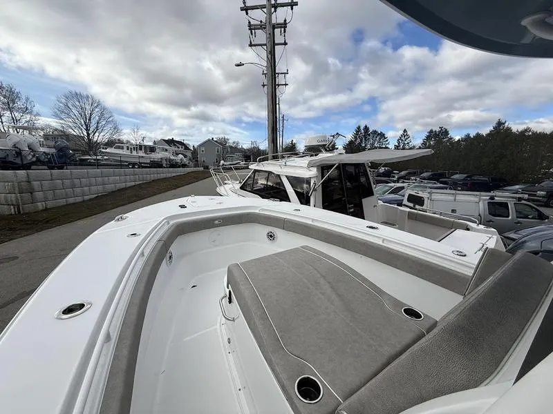 Slide: The Image of 2025 Sea Hunt Gamefish 28 Coffin Box boat, docked, showcasing spacious deck and seating. - 17