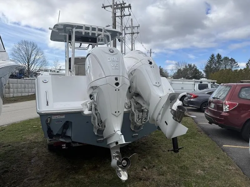 Slide: The Image of 2025 Sea Hunt Gamefish 28 Coffin Box with dual outboard engines, parked outdoors. - 4