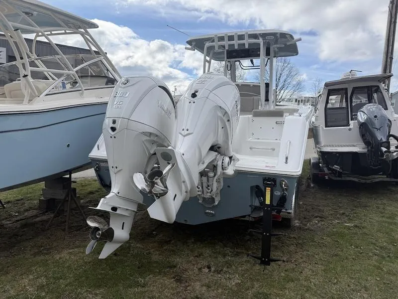 Slide: The Image of 2025 Sea Hunt Gamefish 28 Coffin Box with dual outboard engines, parked on grass. - 5